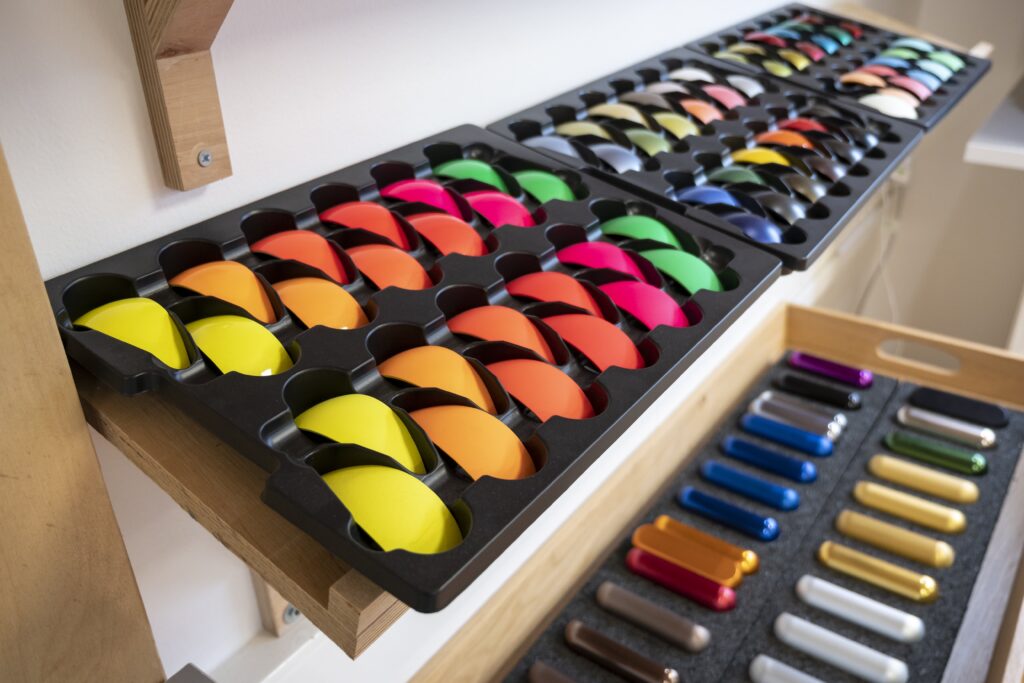 Several trays of different coloured paint swatches on display